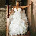 Elegant strapless mermaid wedding dress with luxury sequins, pearls, and organza ruffles - US 4 / White