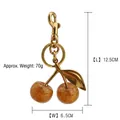 Golden cherry bag charm keychain with brown glitter fruits, weight 70g, length 12.5cm - Rich Gold Shiny Cherry with Bronze Gold