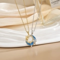 Detail of gold and silver dolphin necklaces with micro-pave crystals and blue enamel - Gold Silver Blue Dolphin Ring Set XL0484