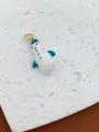 Detail of white enamel penguin pendant with blue accents and gold-plated metal ring - Blue Element Streamlined Pendant
