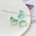 Detailed view of three green crescent glass beads for DIY jewelry making in a white dish - Transparent Green Crescent (9# 10Pcs Price)