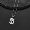 Macro shot of silver stainless steel rectangular pendant with hollow number six on box chain - Number 6