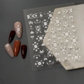 5D embossed white floral nail art stickers Co-311 on assorted solid color faux nails - 5D Relief Silver Stamping Style (CO-311)