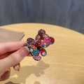 Close-up of a sparkling bear hair clip featuring colorful rhinestones in a detailed view - 1 Piece / Colorful