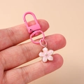 Detail of pink enamel cherry blossom keychain with gold accents and lobster clasp - Pink Flower