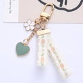 Daisy keychain with white flower, green heart pendant and embroidered lace ribbon - Heart Rope