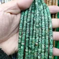 Detailed view of turquoise green disc beads with natural black mineral veins for DIY jewelry - Roadside Stone