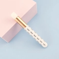 Portable nose cleaning brush with white bristles and gold ferrule on pink cube - White With Lash Pattern