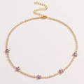 Elegant gold flower necklace with purple zircon stones on a white background - Purple