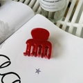 Glossy red medium claw clip for hair styling shown on an open book background - Red (Medium 4.8cm)