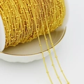 Macro shot of 18K gold-plated beaded chain on a spool showing texture and shine - 1.5mm Small Beaded Chain / Thick Silver