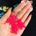 Detailed view of pink translucent resin gummy bear charms on a metallic keychain - Rose Red