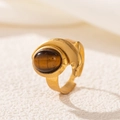 Macro view of 18K gold stainless steel ring with turquoise oval stone and dolphin design - Dolphin Tiger Eye Style (2549-8)