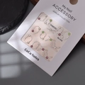 Close-up of mixed silver alloy nail charms with pink and green crystals for DIY manicure - Silver