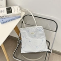 Detail of blue striped canvas tote bag featuring delicate blue bow embroidery - Blue Stripe Blue Bow