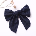 Close-up of navy blue embroidered cotton bow hair clip on a minimalist white background - Navy Blue