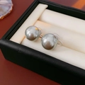 Macro shot of silver-tone clip-on earrings with large iridescent grey pearls in jewelry box - Diameter 14mm / Silver Base Grey Pearl (14mm)