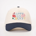 Close-up of Happy Go Lucky embroidery and dice icons on two-tone baseball cap - Cream/Navy Blue