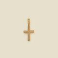 Single polished golden cross pendant with a high-gloss finish on a beige background - Cross Pendant