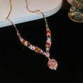 Macro detail of V-shaped gold necklace set with multi-colored gems and heart pendant - Necklace Style (5803585102202) / Gold-Pink-Multicolor