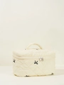 Quilted cream vanity case featuring black embroidered bows and dual zipper closure - Large Handbag / Beige