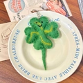 Handmade green wool felt four-leaf clover keychain with a cute smiling face on a plate - Clover