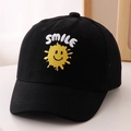 Close-up of smile embroidery and yellow sun graphic on a black cotton baseball cap - 52cm 2-5 Years Old / Black