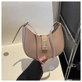 Detail of a beige crescent moon underarm bag with a glossy metallic buckle and thin strap - Khaki