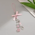 Detail view of a pink ribbon bow keychain with star pendants and heart charms - Pink Star Charm Style (0216)