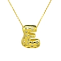 Macro shot of 18k gold plated letter E pendant with sparkling zircon gemstones - Letter E / Gold