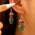 Close-up of cute acrylic Christmas highland cow earrings worn on ear for party style - Christmas Bull Style (N-928)