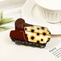 Detail of hair claw clip with sunflower print and woman silhouette on white bowl - Yellow Boots - Sunflower
