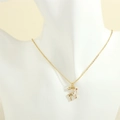 Detail of reindeer pendant with white enamel and colorful crystals on a gold chain - Deer