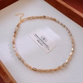 Detail of amber bead necklace with golden adjustable chain and elegant lobster clasp - Gold-Brown Amber/Cat's Eye Texture
