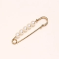 Close-up of gold metal waist pin brooch featuring five elegant white pearls - 5.5cm 5 Pearls Gold