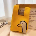 Knitted tote bag in vibrant yellow with cartoon duck pattern and thick knit texture - Yellow Duck