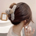 Detail of plush grey shark hair claw clip with a khaki heart on a model hair style - Grey Plush Heart
