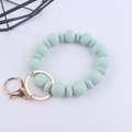 Close-up of light green silicone beads and gold metal ring on a wristlet keychain - Light Green