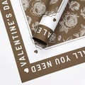 Dark brown Valentine's wrapping paper with white rose patterns and festive typography - Rose Garden / Milk Tea Brown