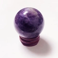 Polished natural purple amethyst crystal ball centerpiece on a dark wooden base stand - Dream Amethyst Ball