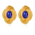 Macro shot of gold swirl earrings featuring an oval blue stone with natural texture - Blue