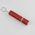Detailed view of red rhinestone-encrusted lipstick tube keychain with silver metal ring - Red