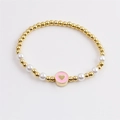 Elegante bracciale con perline dorate, perle bianche e un ciondolo a cuore in smalto rosa - Rosa