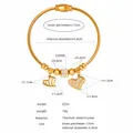 Detail view of gold titanium steel braided bracelet with heart charm and crystal beads - Gold (Z255)