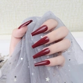 Detailed view of long glossy dark red coffin-shaped press-on nails with UV top coat - Wine Red (CBLL-10)