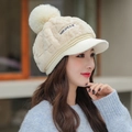 Women's stylish winter plush baseball cap in beige with a cute fur pompom and brim - One Size / Cream