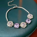 Macro detail of vintage silver bracelet featuring purple square gemstones on a green surface - Purple Square Zirconia Camellia Bracelet (17#) / Silver/Purple