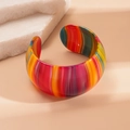 Macro shot of colorful striped acetate open bangle bracelet with wide resin texture - Colorful