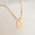 Detailed close-up of a 18K gold-plated rectangle pendant necklace featuring letter G - Letter G
