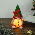 Glow detail of Christmas gingerbread gnome doll with LED light on dark wood base - Gingerbread Man Glowing Gnome Female